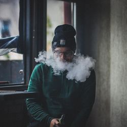 Portrait of young man smoking