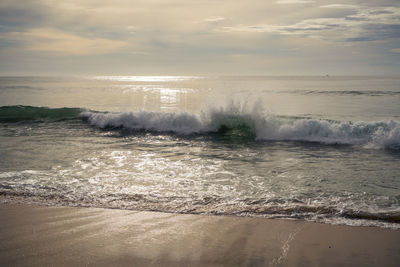 Beautiful waves and clouds over the sea at sunset. warm pastels tones