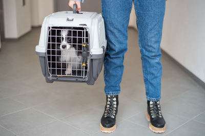 Low section of man standing on tiled floor