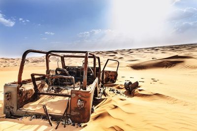 Abandoned sand dune in desert against sky