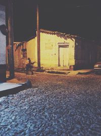 Street amidst buildings in city at night