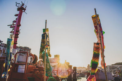 Low angle view of koinobori against sky on sunny day