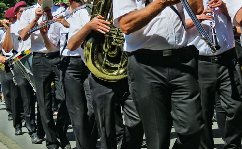 Panoramic view of marching band on road