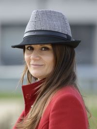 Portrait of smiling young woman wearing hat