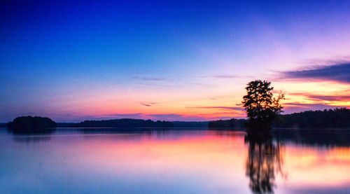 Scenic view of lake against romantic sky at sunset