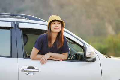 Portrait of a young woman in car