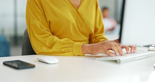 Midsection of business colleagues working at office