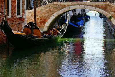 People in boat on canal along buildings