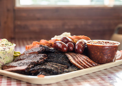 Stack of smoked meats on a tray