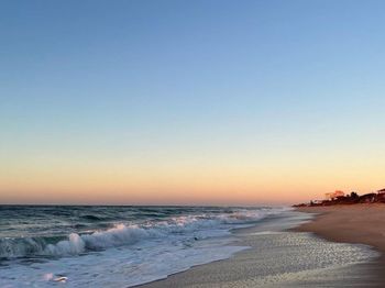 Scenic view of sea against clear sky during sunset