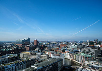 High angle view of buildings against blue sky