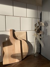 White vase on table against wall