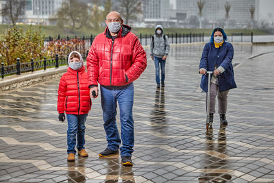 Full length of father and son standing in winter