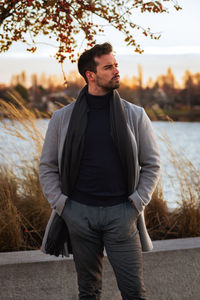 Man in front of water and vegetation