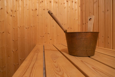 Old saucepan on wooden table in kitchen