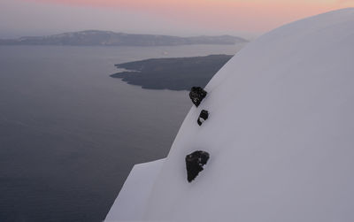 High angle view of sea by mountain against sky