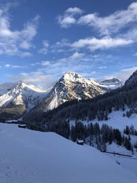 Scenic view of snow covered mountains against sky