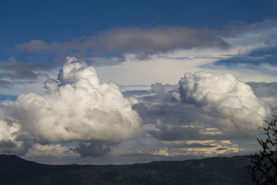 Scenic view of majestic mountains against dramatic sky