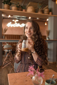 Young beautiful woman enjoying her coffee at coffee shop