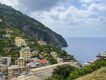 High angle view of townscape by sea against sky