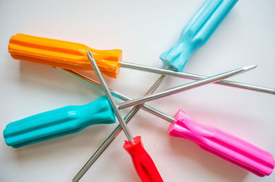 Close-up of colored pencils over white background