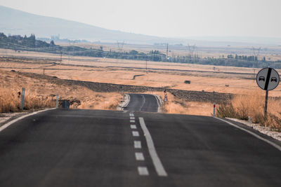 Empty road passing through landscape