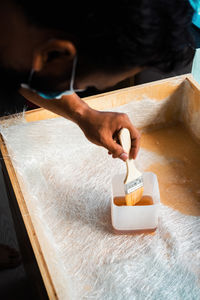 Cropped hand of man working on table