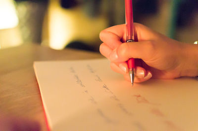 Close-up of woman writing letter