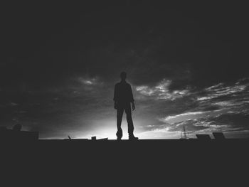 Rear view of silhouette man against sky