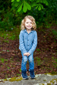 Portrait of cute girl standing on land