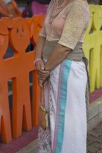 Rear view of women standing on cross