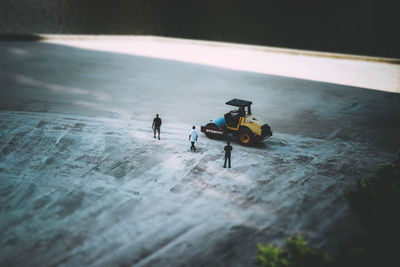 High angle view of people playing with toy car