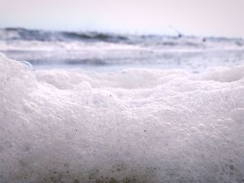 Close-up of waves in sea against sky