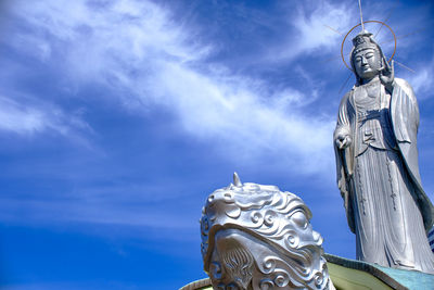 Low angle view of statue against sky