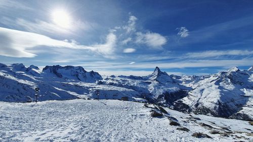 Scenic view of snowcapped mountains against sky