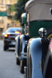 Close-up of cars on road