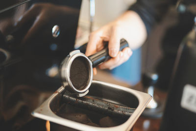 Close-up of man holding coffee cup