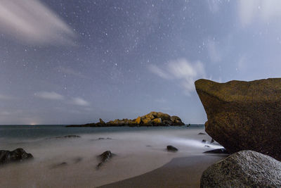 Scenic view of sea against sky at night