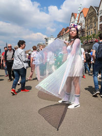 People on street in city against sky