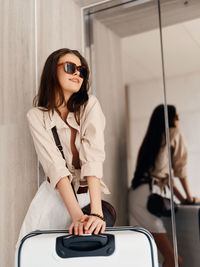 Portrait of young woman sitting at home