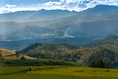 Scenic view of landscape and mountains against sky