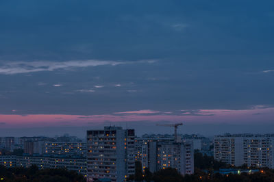 High angle view of illuminated buildings against sky at sunset