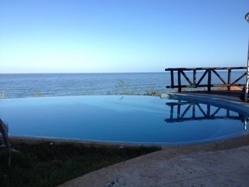 Scenic view of sea against clear blue sky