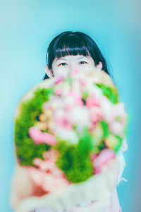 Portrait of woman holding flower