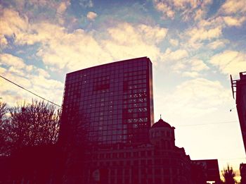 Low angle view of building against cloudy sky