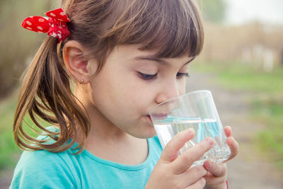 Close-up of girl drinking glass