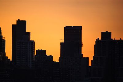 Buildings against clear sky during sunset