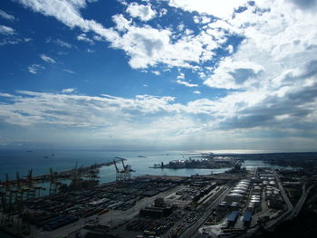 High angle view of buildings and sea against sky