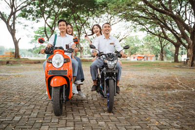 Side view of man riding motorcycle on road