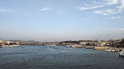 Scenic view of river by buildings against sky